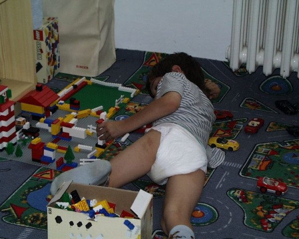 8 year old diaper boy Tommy Wearing his plastic pampers